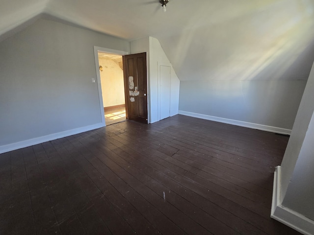 bonus room with lofted ceiling and dark hardwood / wood-style floors