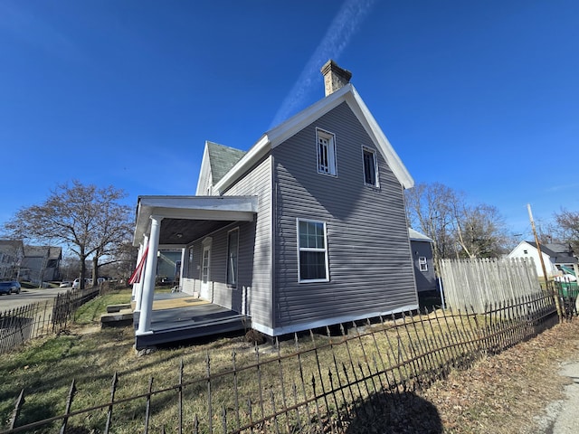 view of side of property with a porch