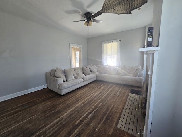 unfurnished living room featuring dark wood-type flooring and ceiling fan