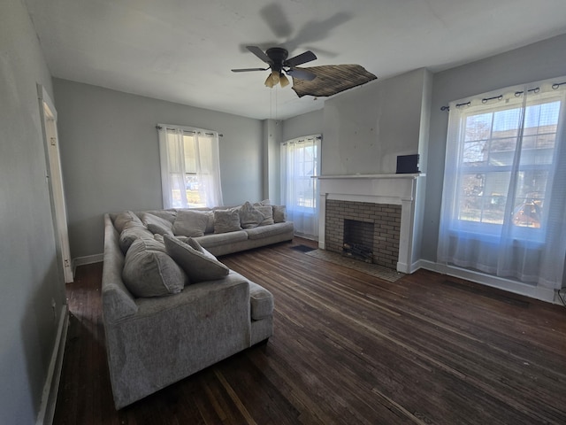 living room with ceiling fan, a fireplace, and dark hardwood / wood-style flooring