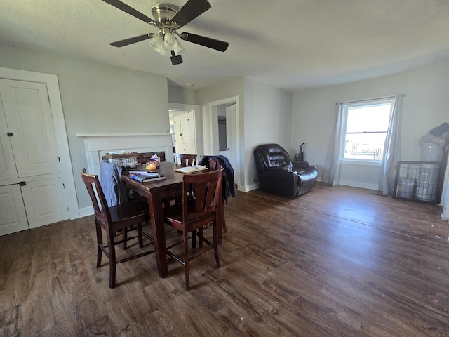 dining space featuring ceiling fan, dark hardwood / wood-style floors, and a textured ceiling