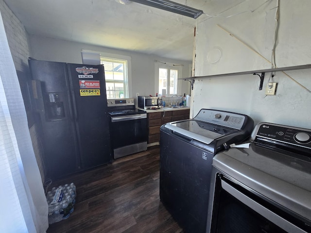 laundry room with dark hardwood / wood-style flooring, sink, and washing machine and dryer