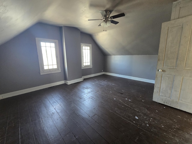 additional living space with ceiling fan, lofted ceiling, and dark hardwood / wood-style flooring