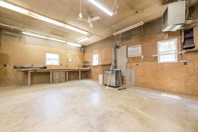 312 E Buckeye St, Belle Center, OH 43310 - garage featuring a heating unit, a wall unit AC, and a workshop area
