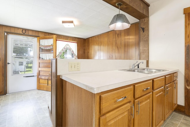 312 E Buckeye St, Belle Center, OH 43310 - kitchen with a sink, wooden walls, light countertops, healthy amount of natural light, and brown cabinets
