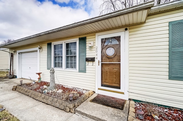 doorway to property with an attached garage