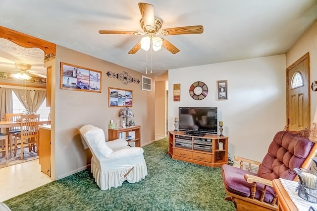 living room featuring ceiling fan, carpet floors, visible vents, and baseboards