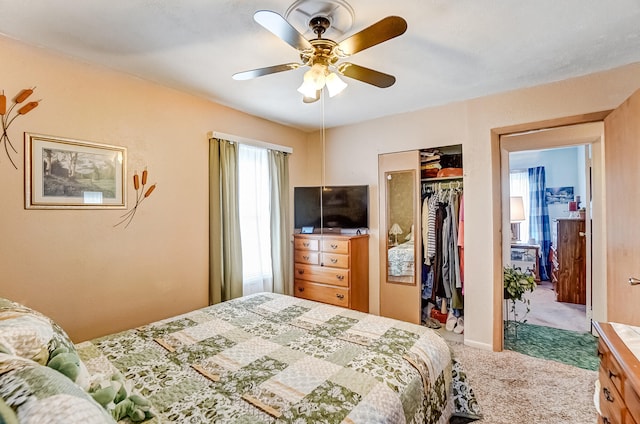 carpeted bedroom with a closet and a ceiling fan