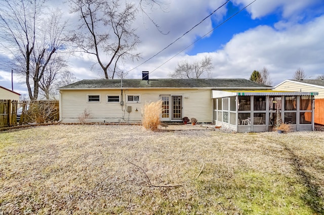 rear view of property with a sunroom and fence