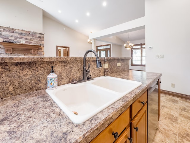 interior space featuring recessed lighting, brown cabinets, dishwasher, a sink, and a chandelier