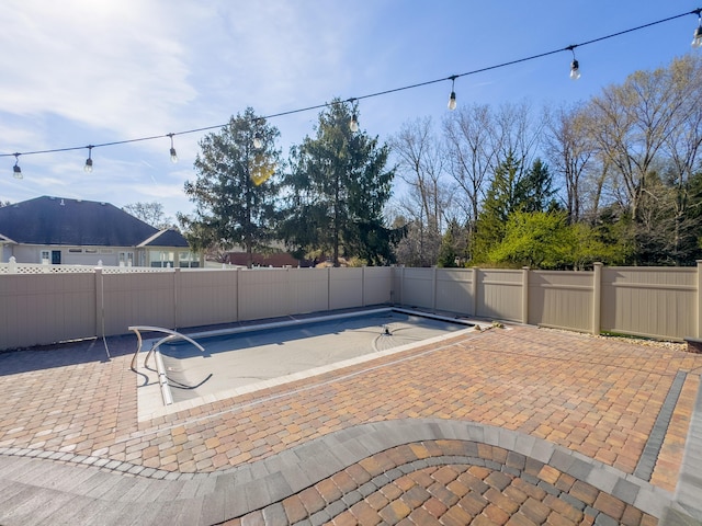 view of pool featuring a patio area, a fenced backyard, and a fenced in pool