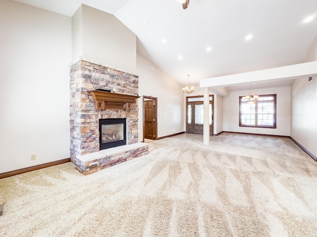 unfurnished living room with a stone fireplace, carpet flooring, baseboards, and an inviting chandelier