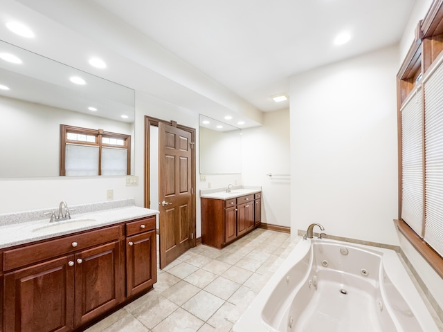 full bath with tile patterned floors, a sink, a jetted tub, two vanities, and recessed lighting