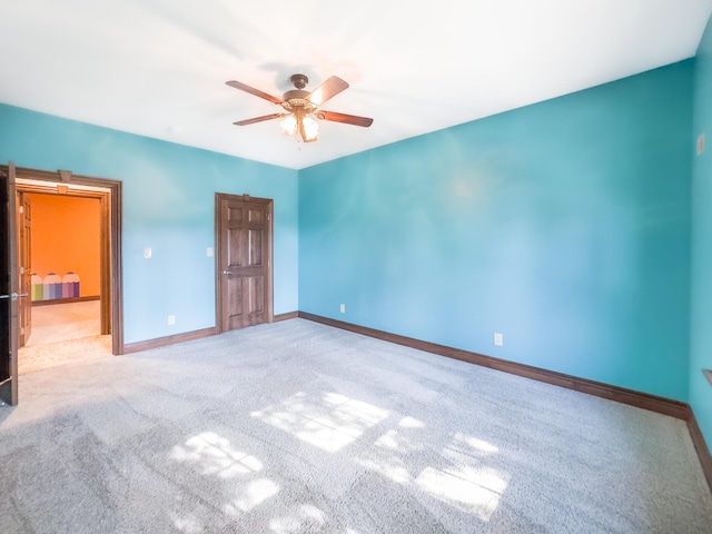 unfurnished bedroom with a ceiling fan, baseboards, and carpet floors