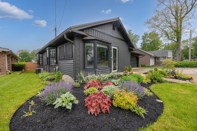11181 Elm St, Lakeview, OH 43331 - view of front of property with a garage, board and batten siding, cooling unit, and driveway