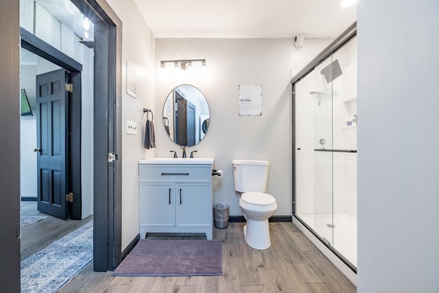11181 Elm St, Lakeview, OH 43331 - full bathroom with wood finished floors, a shower stall, toilet, vanity, and baseboards