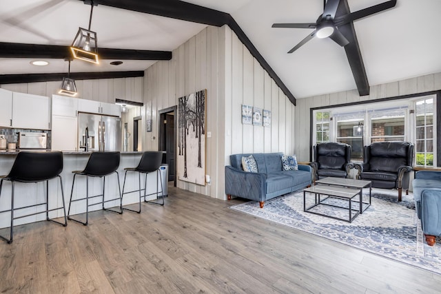 11181 Elm St, Lakeview, OH 43331 - living area featuring light wood-style floors, ceiling fan, and wooden walls