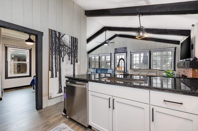 11181 Elm St, Lakeview, OH 43331 - kitchen with stainless steel dishwasher, a sink, a ceiling fan, white cabinetry, and wood finished floors