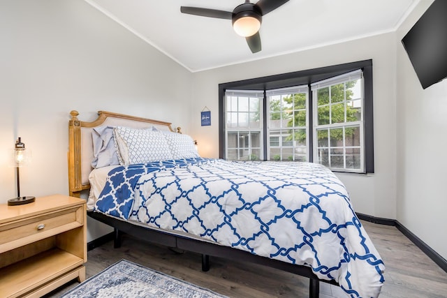 11181 Elm St, Lakeview, OH 43331 - bedroom featuring crown molding, vaulted ceiling, wood finished floors, a ceiling fan, and baseboards