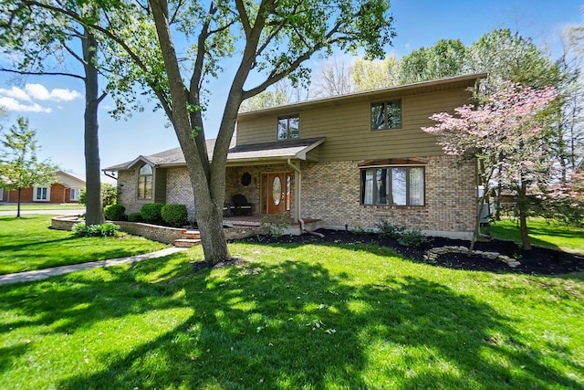 traditional-style home with a front yard and brick siding