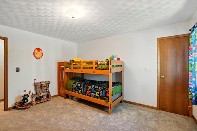 carpeted bedroom with baseboards