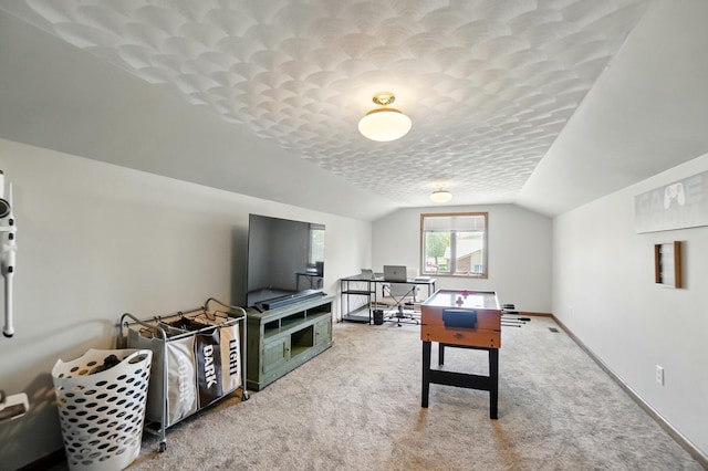 rec room with carpet floors, baseboards, vaulted ceiling, and a textured ceiling