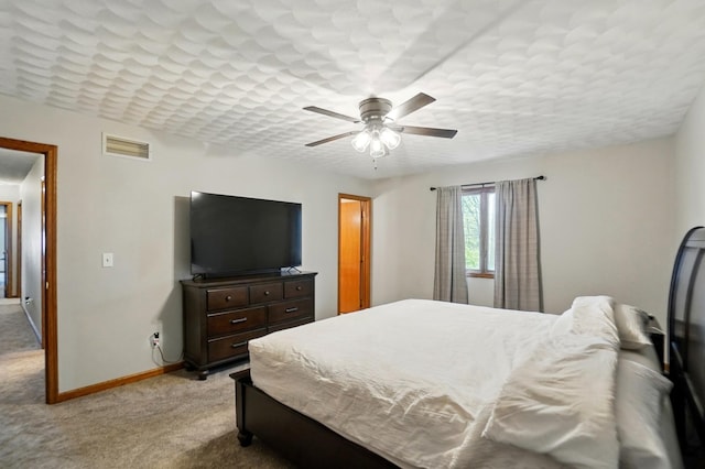 bedroom with a ceiling fan, baseboards, visible vents, and light carpet