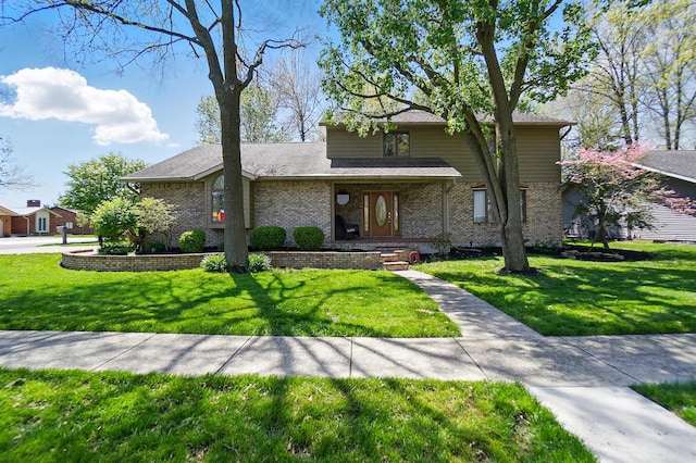 view of front of home with brick siding and a front lawn