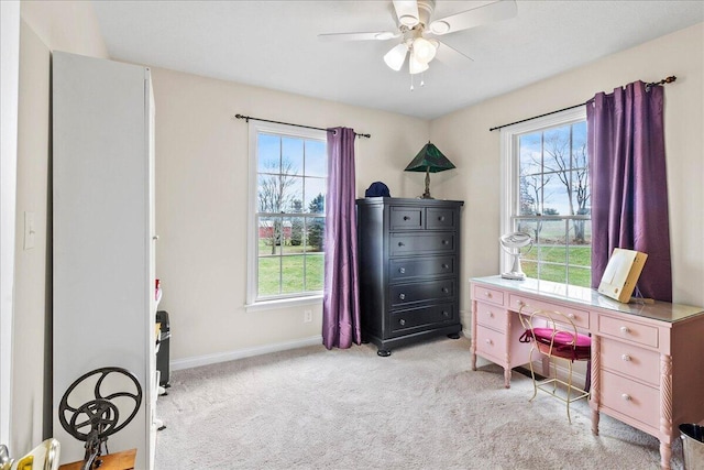 carpeted office space with ceiling fan