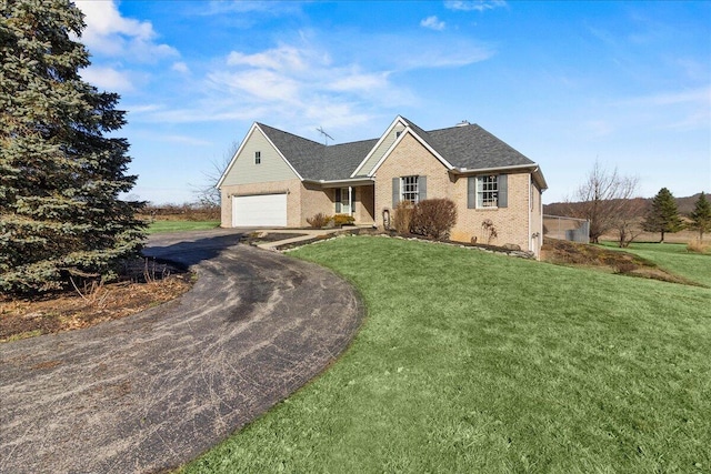 view of front of property with a garage and a front lawn