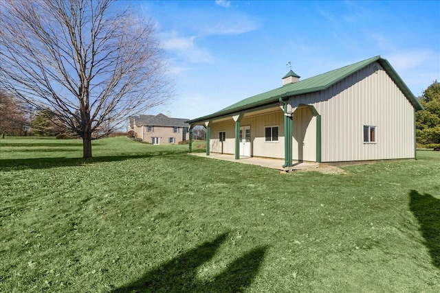 view of home's exterior with a yard and a patio area