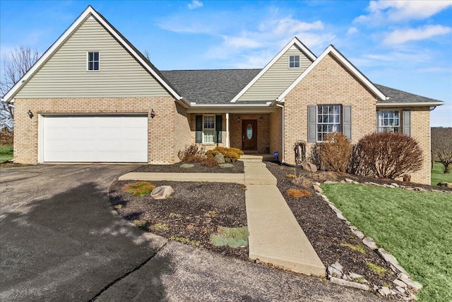 view of front of house featuring a garage and a front lawn