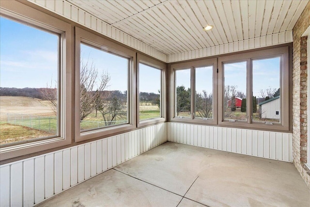 unfurnished sunroom with wooden ceiling