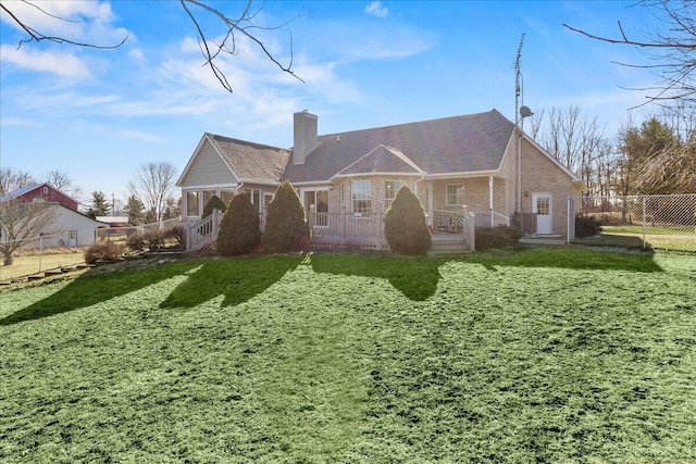 back of house featuring a yard and a porch