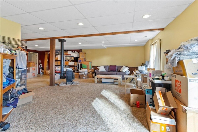 living room featuring carpet and a wood stove