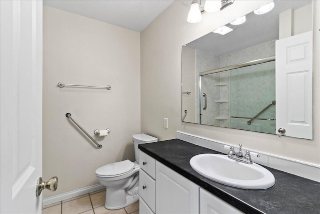 bathroom featuring vanity, tile patterned floors, toilet, and walk in shower