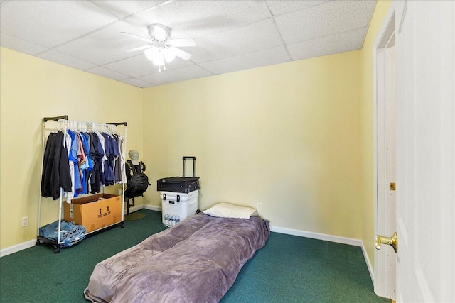 carpeted bedroom featuring a paneled ceiling and ceiling fan