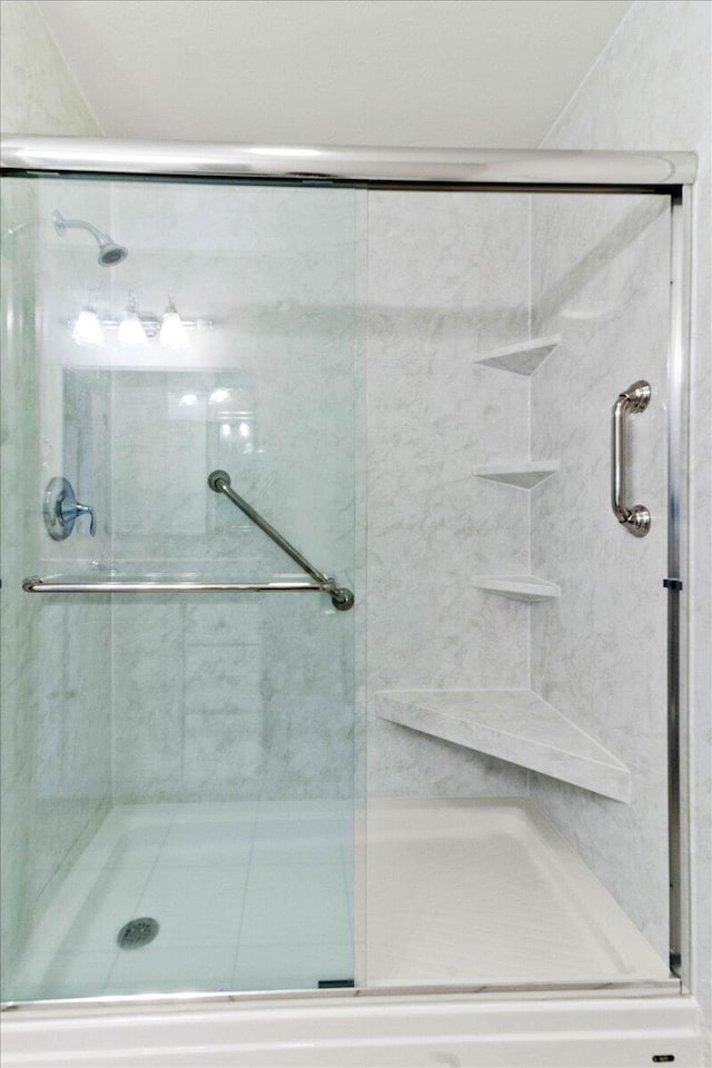 bathroom with a shower with door