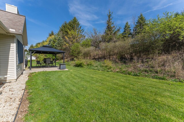view of yard featuring a gazebo and a patio area