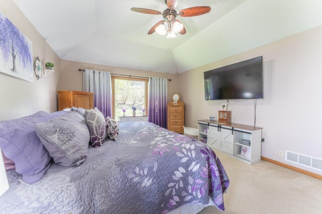 carpeted bedroom featuring baseboards, vaulted ceiling, visible vents, and ceiling fan