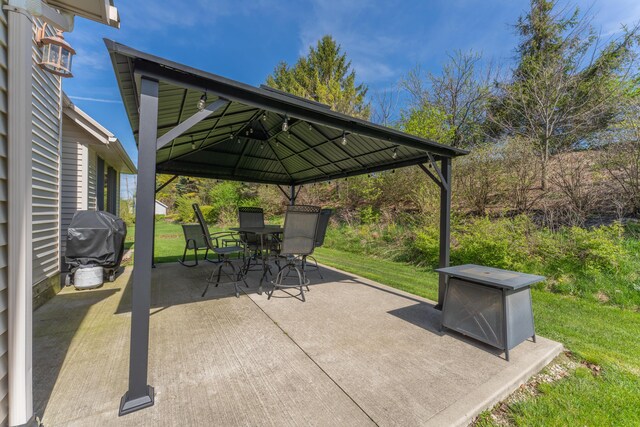 view of patio with outdoor dining area, a gazebo, and area for grilling