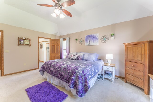 bedroom featuring lofted ceiling, a ceiling fan, baseboards, and light colored carpet