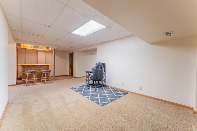 living area featuring baseboards, visible vents, carpet, and a bar