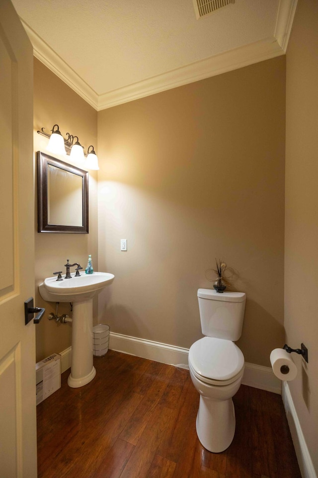 429 Braytonburne Dr, Springfield, OH 45503 - half bath featuring wood finished floors, ornamental molding, toilet, and baseboards
