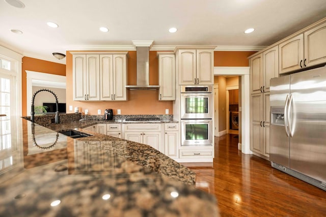 429 Braytonburne Dr, Springfield, OH 45503 - kitchen featuring appliances with stainless steel finishes, wall chimney exhaust hood, crown molding, dark wood-style floors, and a sink