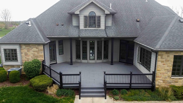 429 Braytonburne Dr, Springfield, OH 45503 - back of property with stone siding, a wooden deck, and roof with shingles