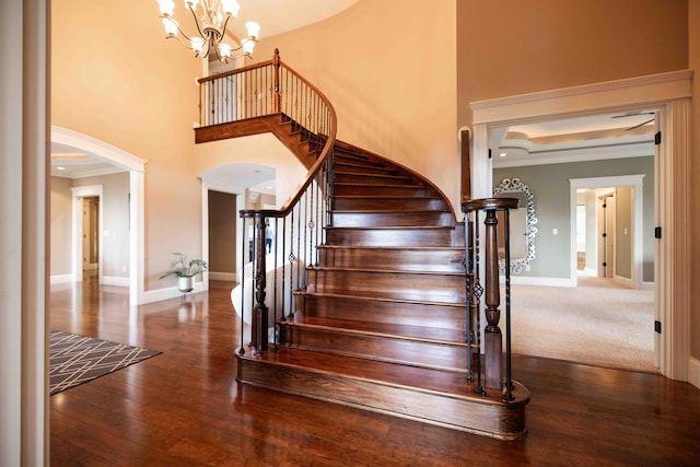 429 Braytonburne Dr, Springfield, OH 45503 - stairway with arched walkways, ornamental molding, baseboards, a chandelier, and wood finished floors
