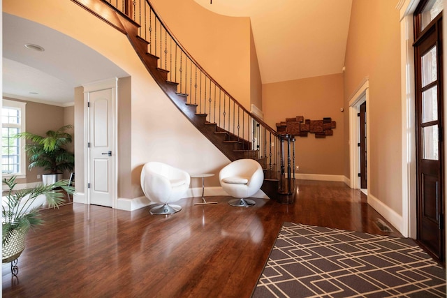 429 Braytonburne Dr, Springfield, OH 45503 - foyer with wood finished floors, baseboards, a towering ceiling, stairway, and arched walkways