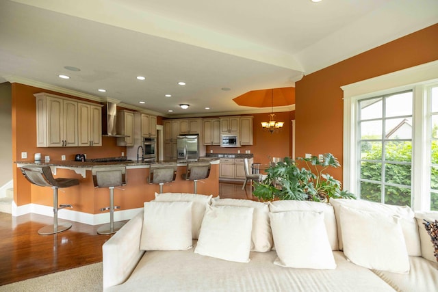 429 Braytonburne Dr, Springfield, OH 45503 - kitchen with stainless steel appliances, wall chimney exhaust hood, a breakfast bar area, a peninsula, and open floor plan