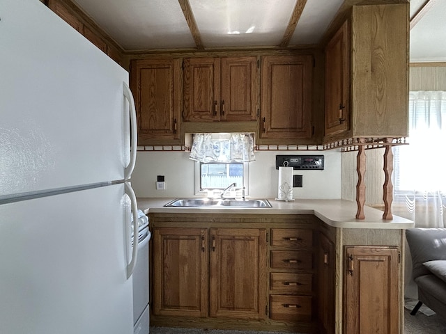 11240 Mohawk Path, Lakeview, OH 43331 - kitchen with white appliances, a sink, light countertops, and brown cabinets